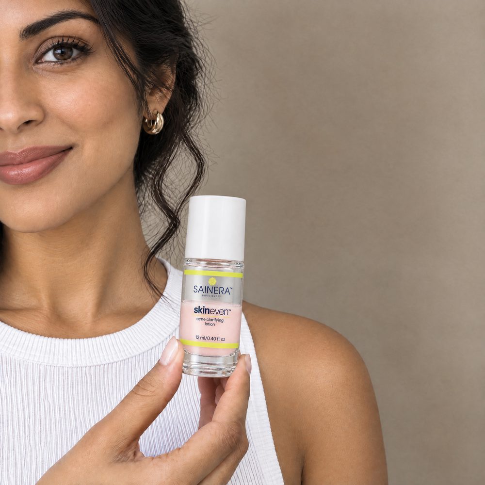 Woman holding Skineven Acne Clarifying Lotion