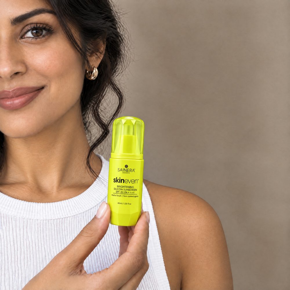 Woman holding Skineven Brightening Silicone Sunscreen SPF 50 PA++++
